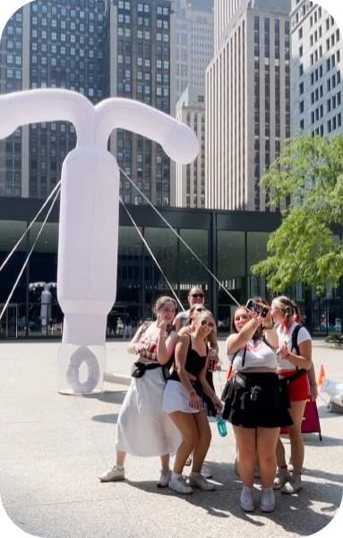 Image of women in front of large blowup IUD